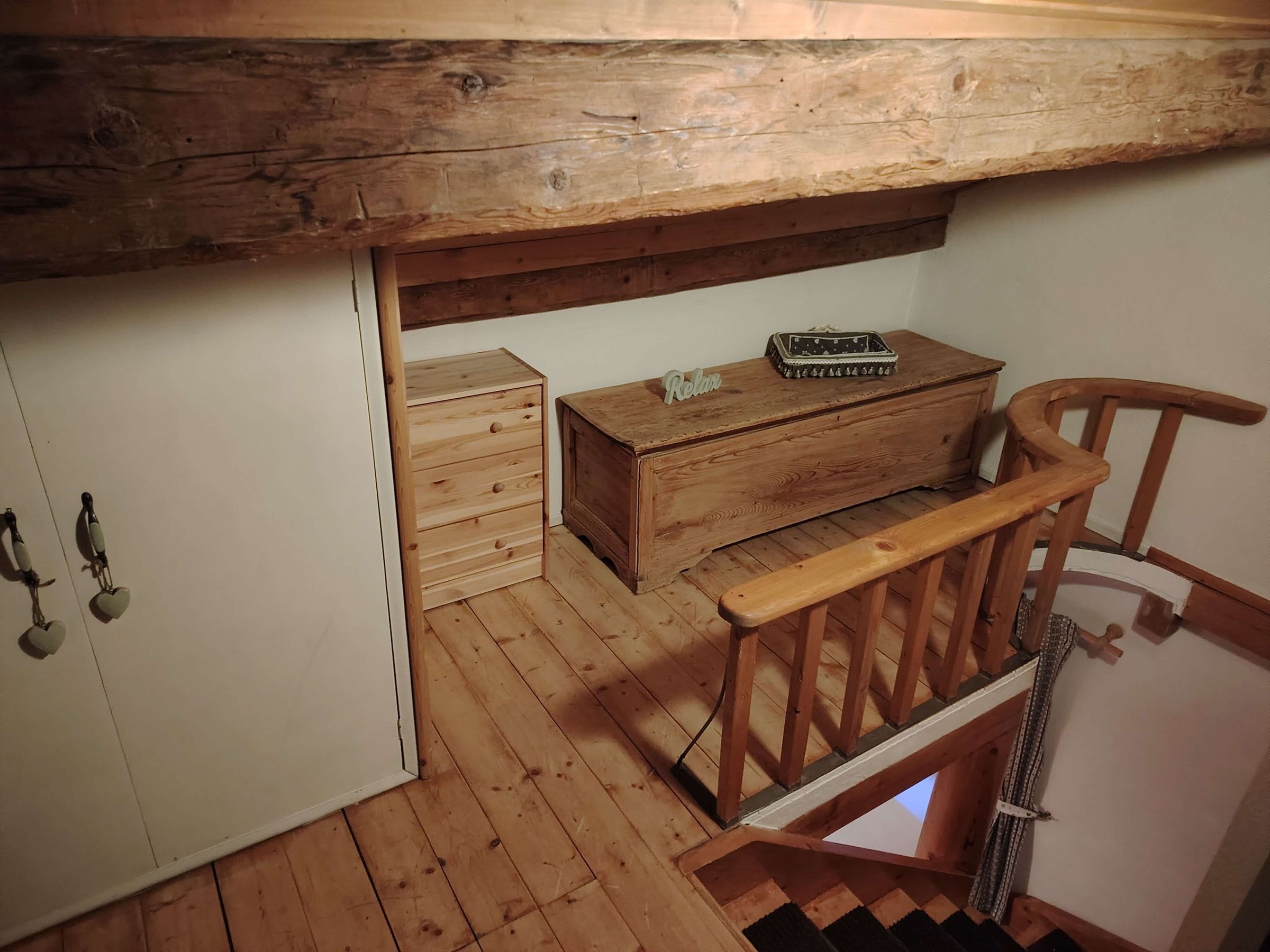 Dachgeschoss mit sichtbaren Balken und Holztruhe